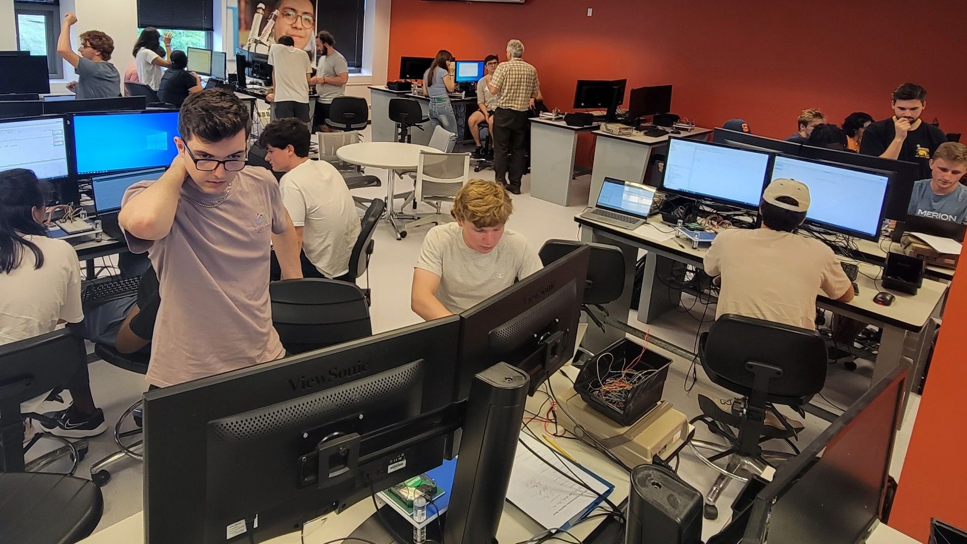 A large group of ECS students working on projects at computers